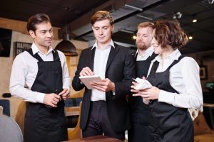 Serious restaurant manager dividing responsibilities among waite